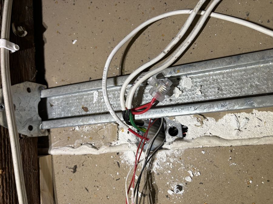 Unprotected live wiring connection found in a roof space during an electrical inspection
